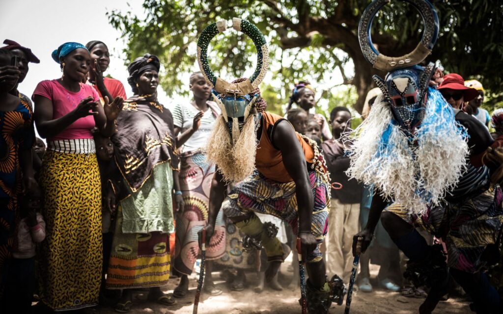 On a TravPholer tour to Mali in West Africa, travellers watch local community members perform a ritual